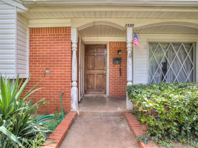 2400 NW 111th St, Oklahoma City, OK 73120 - doorway to property featuring brick siding
