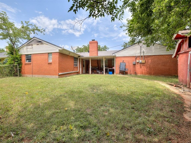 2400 NW 111th St, Oklahoma City, OK 73120 - back of house with brick siding and a chimney