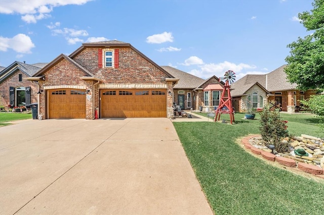 13117 SW 2nd Ter, Yukon, OK 73099 - view of front facade with brick siding, concrete driveway, a front lawn, and a garage