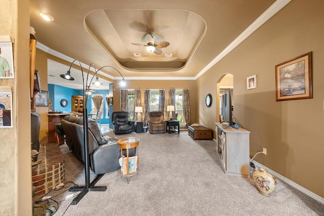 13117 SW 2nd Ter, Yukon, OK 73099 - living room featuring carpet, a tray ceiling, ceiling fan, arched walkways, and ornamental molding