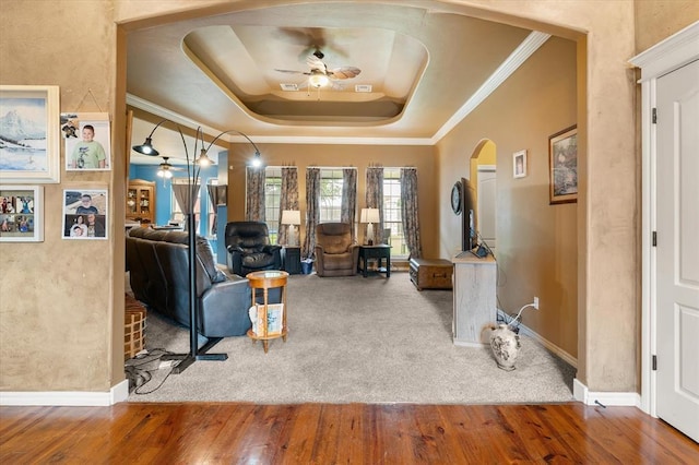 13117 SW 2nd Ter, Yukon, OK 73099 - living room with ceiling fan, arched walkways, a tray ceiling, wood finished floors, and crown molding