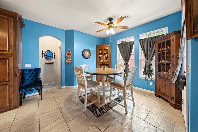 13117 SW 2nd Ter, Yukon, OK 73099 - dining area featuring arched walkways, a ceiling fan, and light tile patterned floors