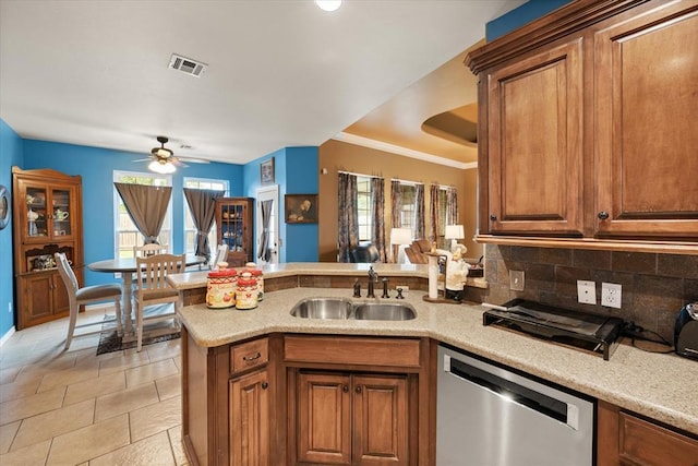 13117 SW 2nd Ter, Yukon, OK 73099 - kitchen with dishwasher, a peninsula, brown cabinetry, a ceiling fan, and ornamental molding