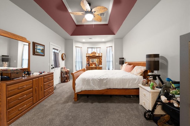 13117 SW 2nd Ter, Yukon, OK 73099 - bedroom featuring carpet flooring, a tray ceiling, and a ceiling fan