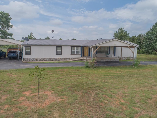 1300 Hutton Rd, Marlow, OK 73055 - view of front of home featuring a metal roof, a front yard, driveway, and a carport