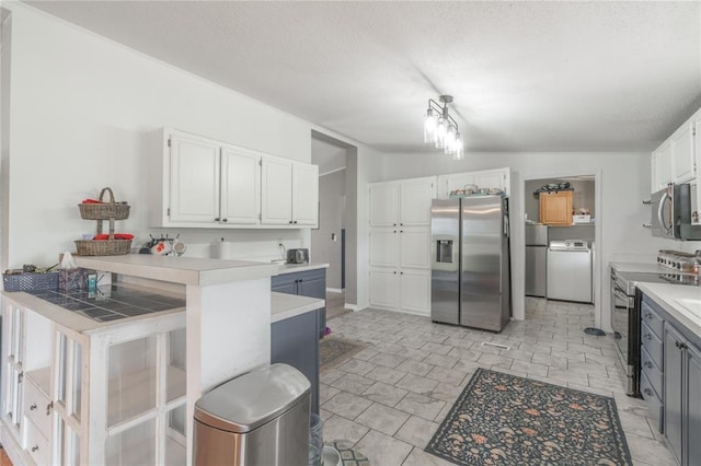1300 Hutton Rd, Marlow, OK 73055 - kitchen featuring appliances with stainless steel finishes, white cabinetry, light countertops, a peninsula, and a textured ceiling