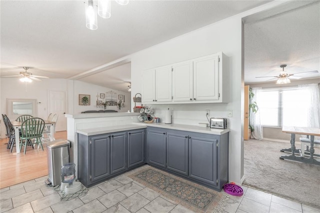 1300 Hutton Rd, Marlow, OK 73055 - kitchen with ceiling fan, white cabinets, light countertops, vaulted ceiling, and a textured ceiling