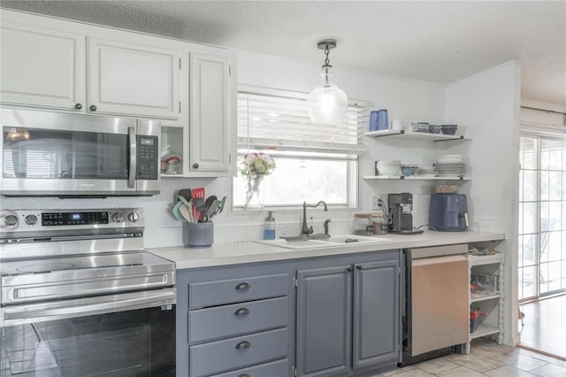 1300 Hutton Rd, Marlow, OK 73055 - kitchen with stainless steel appliances, open shelves, white cabinets, and light countertops