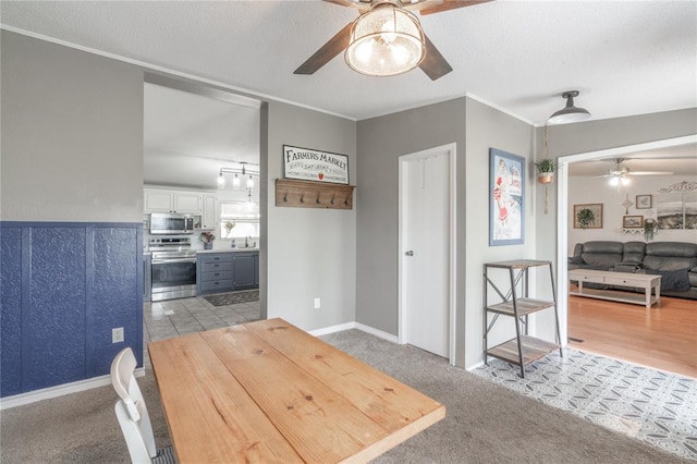 1300 Hutton Rd, Marlow, OK 73055 - dining space with a ceiling fan, a textured ceiling, crown molding, and light colored carpet