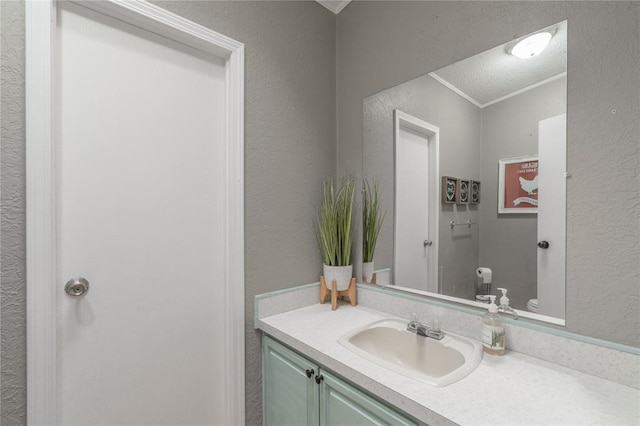 1300 Hutton Rd, Marlow, OK 73055 - bathroom featuring vanity, a textured wall, and crown molding