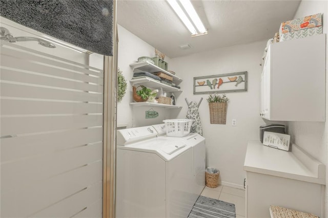 1300 Hutton Rd, Marlow, OK 73055 - washroom featuring washer and clothes dryer, cabinet space, and light tile patterned floors