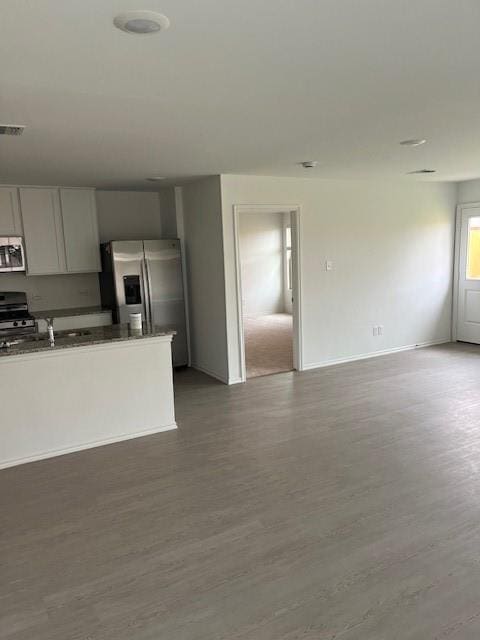 9616 NW 125th Ter, Yukon, OK 73099 - kitchen with stainless steel appliances, wood finished floors, dark countertops, and open floor plan