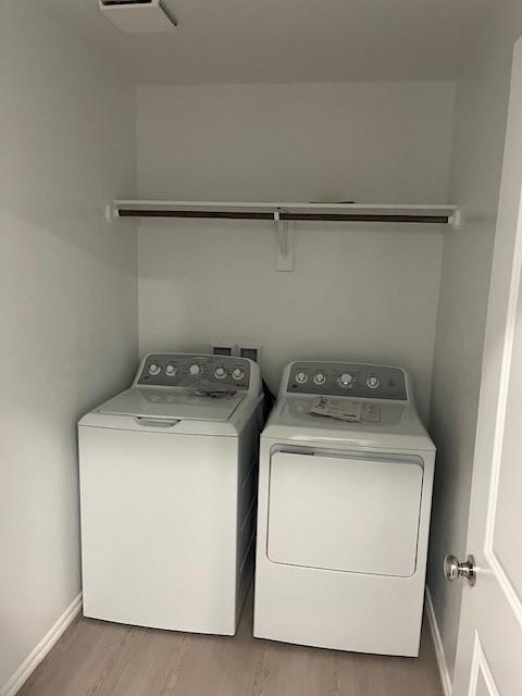 9616 NW 125th Ter, Yukon, OK 73099 - washroom with washing machine and dryer and wood finished floors