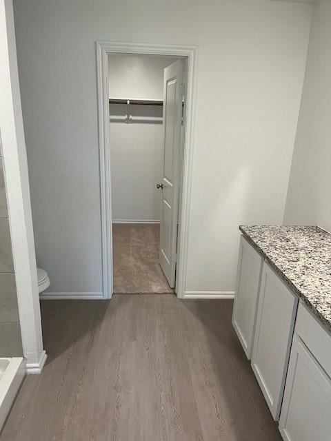 9616 NW 125th Ter, Yukon, OK 73099 - bathroom with wood finished floors, a walk in closet, a tile shower, and vanity