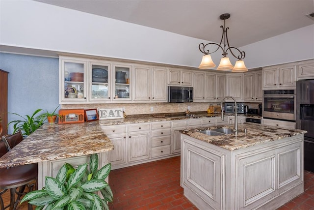 105074 N 3770th Rd, Okemah, OK 74859 - kitchen featuring appliances with stainless steel finishes, brick floors, a peninsula, and backsplash