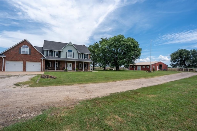 105074 N 3770th Rd, Okemah, OK 74859 - colonial inspired home featuring a porch, driveway, brick siding, and a front yard