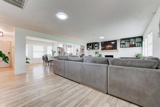 2401 Big Cedar Ave, Edmond, OK 73012 - living room featuring light wood finished floors, a fireplace, and recessed lighting