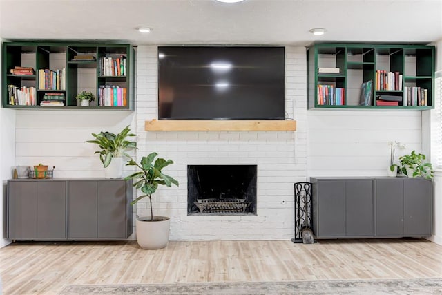 2401 Big Cedar Ave, Edmond, OK 73012 - living room featuring wood finished floors and a fireplace