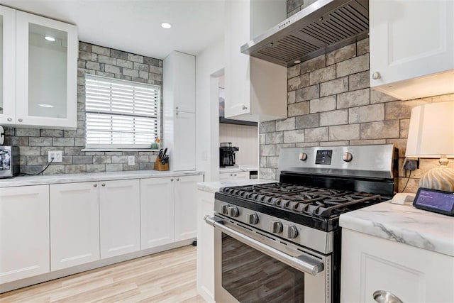 2401 Big Cedar Ave, Edmond, OK 73012 - kitchen featuring stainless steel gas range oven, custom range hood, tasteful backsplash, white cabinets, and recessed lighting