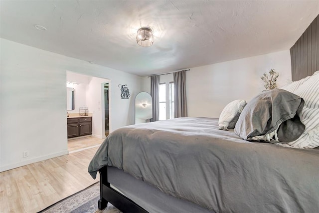 2401 Big Cedar Ave, Edmond, OK 73012 - bedroom featuring light wood-type flooring and ensuite bath