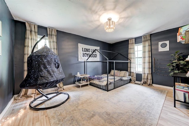 2401 Big Cedar Ave, Edmond, OK 73012 - bedroom with wood finished floors and baseboards