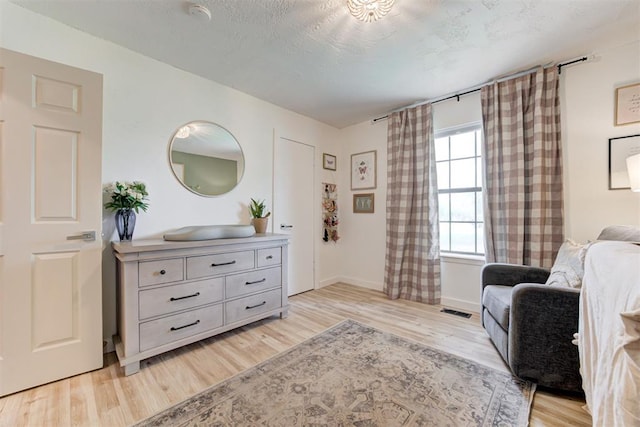 2401 Big Cedar Ave, Edmond, OK 73012 - living area with light wood-style flooring and baseboards