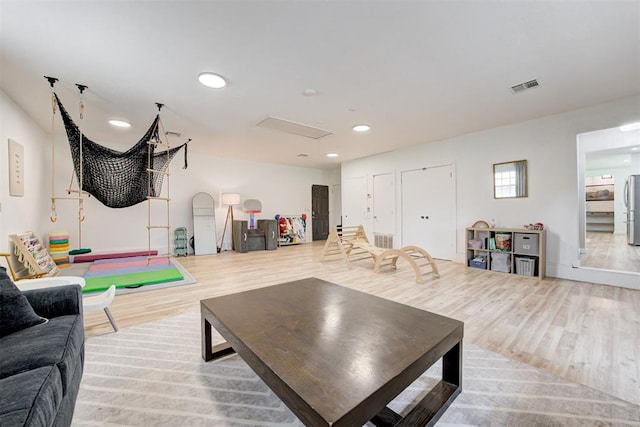 2401 Big Cedar Ave, Edmond, OK 73012 - living room featuring wood finished floors and recessed lighting