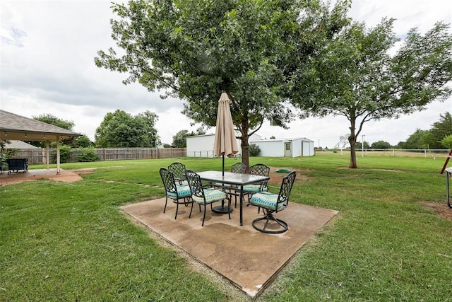 2401 Big Cedar Ave, Edmond, OK 73012 - fenced backyard featuring a patio, a storage unit, and outdoor dining area