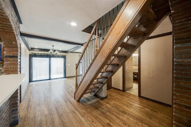 3824 Key Pl, Oklahoma City, OK 73112 - staircase with wood finished floors and a chandelier