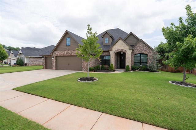 512 NW 186th St, Edmond, OK 73012 - view of front of house with driveway, an attached garage, stone siding, and brick siding