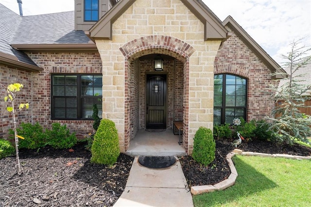 512 NW 186th St, Edmond, OK 73012 - doorway to property featuring brick siding and a shingled roof