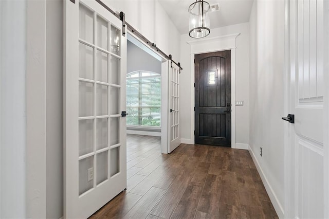 512 NW 186th St, Edmond, OK 73012 - entrance foyer featuring a barn door and dark wood finished floors