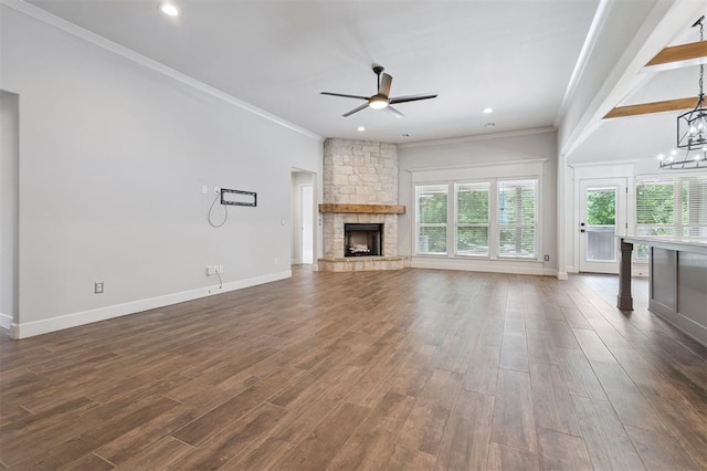 512 NW 186th St, Edmond, OK 73012 - unfurnished living room featuring a ceiling fan, a fireplace, crown molding, dark wood finished floors, and a chandelier