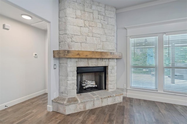 512 NW 186th St, Edmond, OK 73012 - detailed view of wood finished floors, a stone fireplace, and crown molding