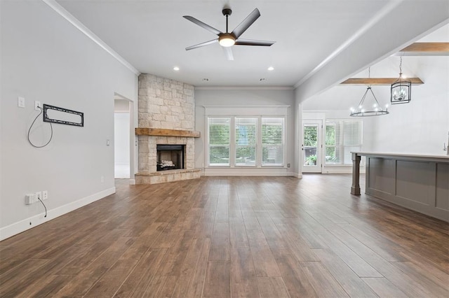 512 NW 186th St, Edmond, OK 73012 - unfurnished living room featuring a chandelier, ornamental molding, a fireplace, dark wood finished floors, and ceiling fan