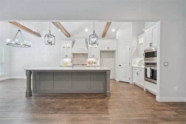 512 NW 186th St, Edmond, OK 73012 - kitchen featuring appliances with stainless steel finishes, custom exhaust hood, a chandelier, backsplash, and beam ceiling