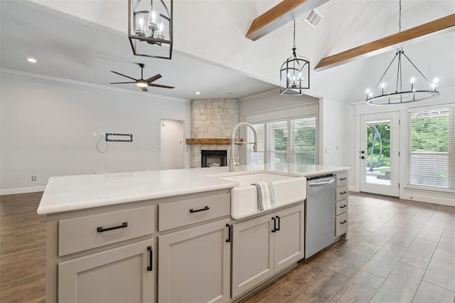 512 NW 186th St, Edmond, OK 73012 - kitchen featuring dishwasher, a chandelier, open floor plan, a stone fireplace, and ornamental molding