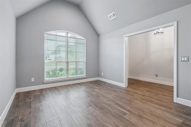 512 NW 186th St, Edmond, OK 73012 - unfurnished room with wood finished floors, vaulted ceiling, and a chandelier
