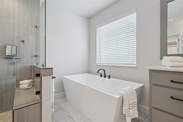 512 NW 186th St, Edmond, OK 73012 - bathroom with a tile shower, a soaking tub, and vanity