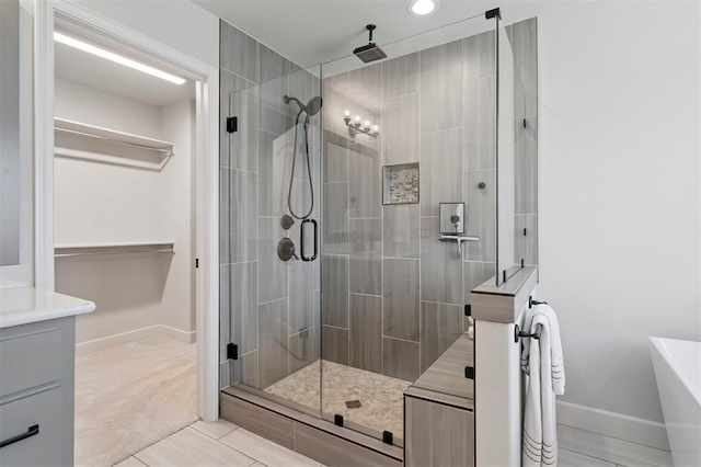 512 NW 186th St, Edmond, OK 73012 - full bath featuring a shower stall, tile patterned flooring, vanity, and a soaking tub
