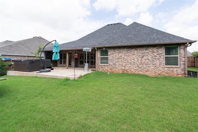 512 NW 186th St, Edmond, OK 73012 - back of house featuring a hot tub, a patio area, roof with shingles, and brick siding