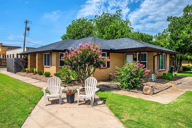 2100 Barclay Rd, Oklahoma City, OK 73120 - single story home with brick siding, a shingled roof, and a patio area