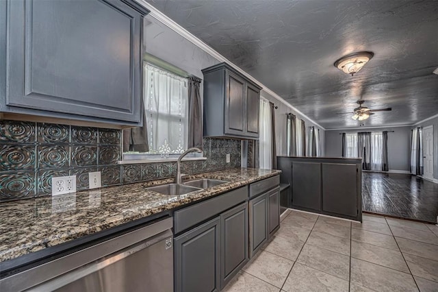 2100 Barclay Rd, Oklahoma City, OK 73120 - kitchen featuring stainless steel dishwasher, a ceiling fan, decorative backsplash, light tile patterned floors, and dark stone countertops