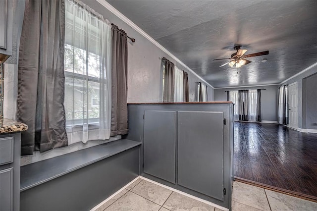 2100 Barclay Rd, Oklahoma City, OK 73120 - kitchen featuring gray cabinets, crown molding, ceiling fan, and light tile patterned floors