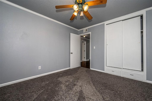 2100 Barclay Rd, Oklahoma City, OK 73120 - unfurnished bedroom featuring carpet flooring, crown molding, a closet, a textured ceiling, and a ceiling fan
