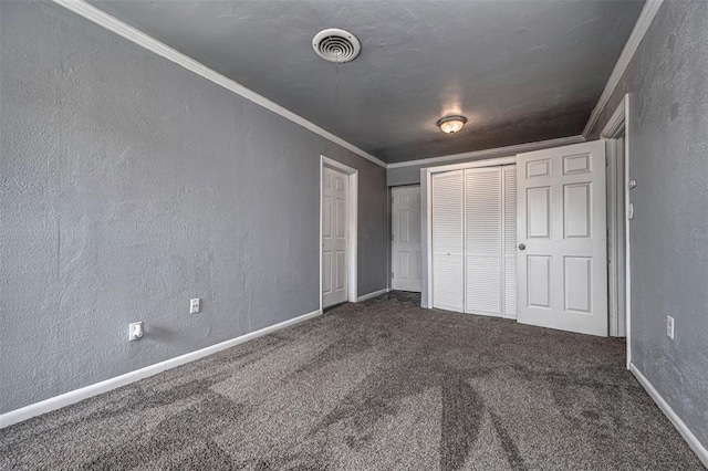 2100 Barclay Rd, Oklahoma City, OK 73120 - unfurnished bedroom featuring crown molding, carpet floors, a textured wall, and a closet