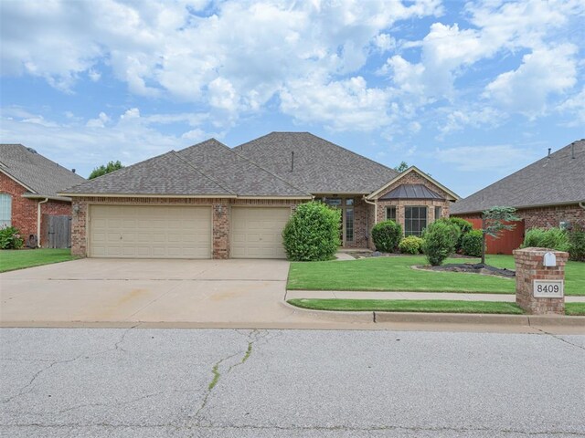 8409 NW 106th St, Oklahoma City, OK 73162 - view of front of property featuring brick siding, a front yard, concrete driveway, and an attached garage