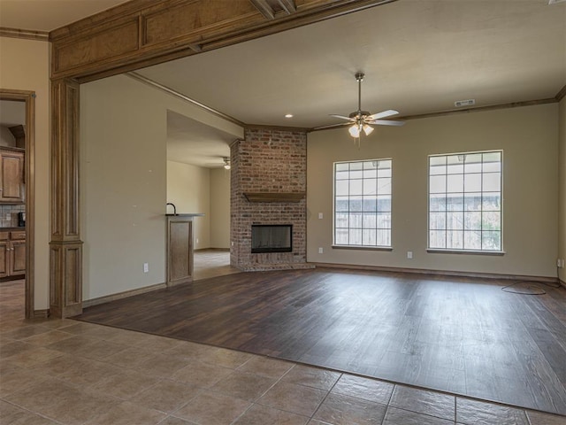 8409 NW 106th St, Oklahoma City, OK 73162 - unfurnished living room with ceiling fan, ornamental molding, wood finished floors, and a fireplace