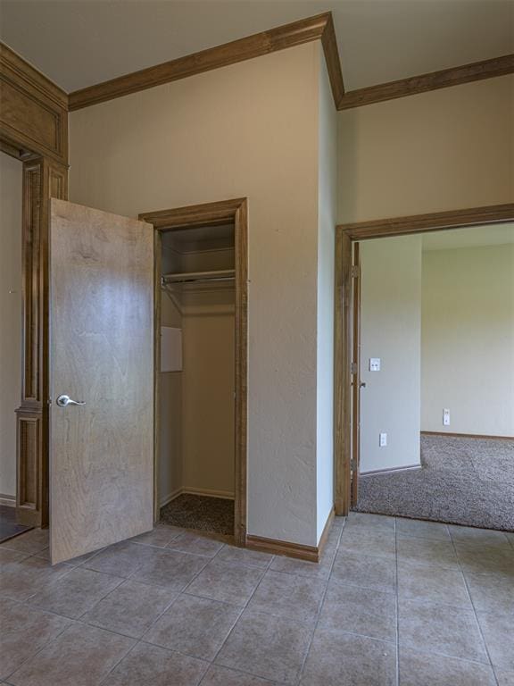 8409 NW 106th St, Oklahoma City, OK 73162 - unfurnished bedroom with crown molding, a closet, and tile patterned flooring