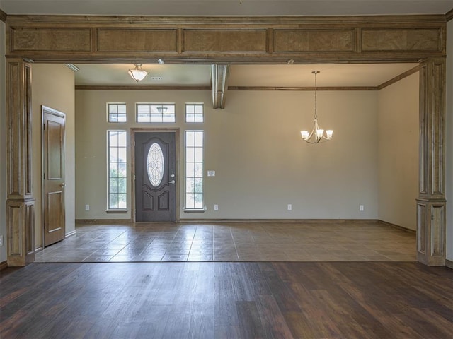 8409 NW 106th St, Oklahoma City, OK 73162 - entrance foyer featuring a chandelier, ornamental molding, and dark wood-style floors